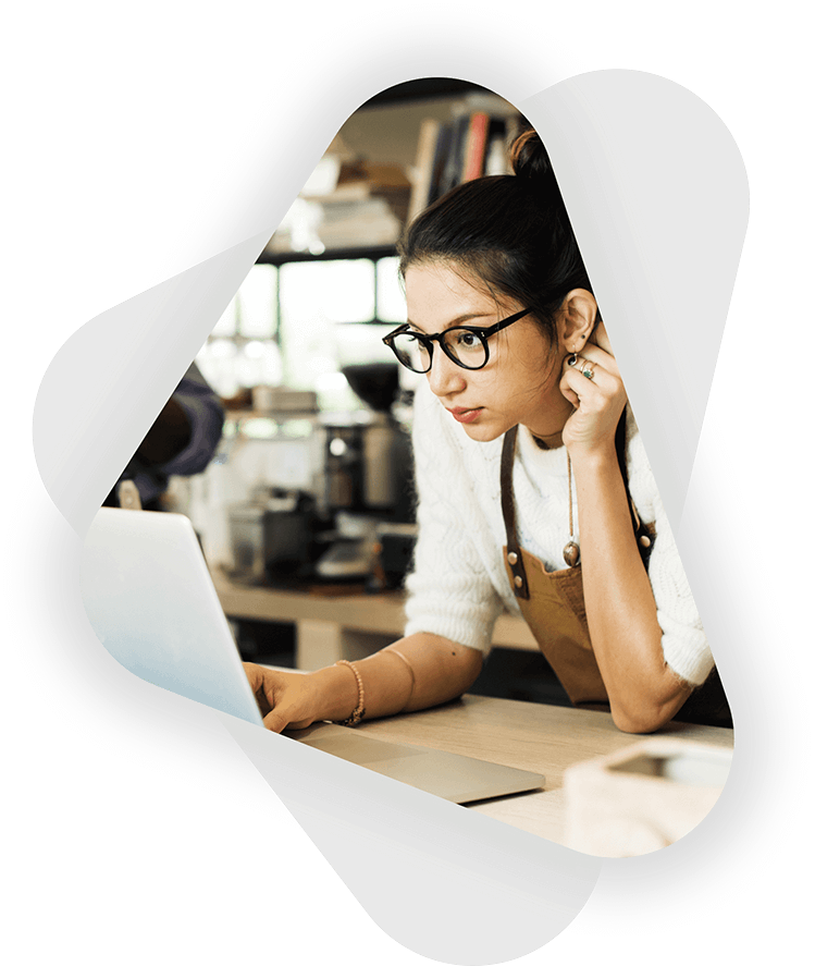 young female cafe owner on laptop at work